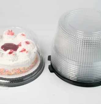 "Round clear cake container by JC Packaging showcasing a frosted cake with colorful sprinkles and strawberry toppings, with an additional stack of clear containers on the right."