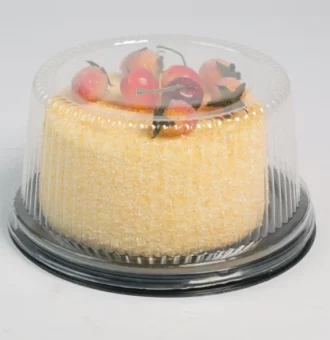 "Elegant JC Packaging clear cake dome encasing a yellow sponge cake topped with sugar-dusted strawberries and cherries, accentuating the dessert's allure."