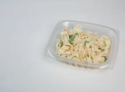 "A fresh coleslaw salad in a JC Packaging clear salad container, emphasizing the crispness and color of the ingredients through the transparent material."