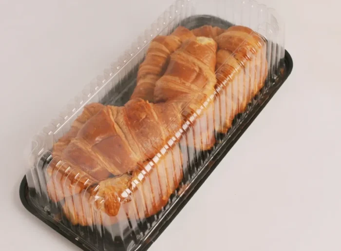"Golden-brown croissants arranged neatly in JC Packaging's transparent croissant display tray, highlighting the product’s freshness and flaky texture."
