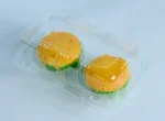 Savory muffins encased in JC Packaging's clear muffin packaging, highlighting the freshness and vibrant colors of the contents within.