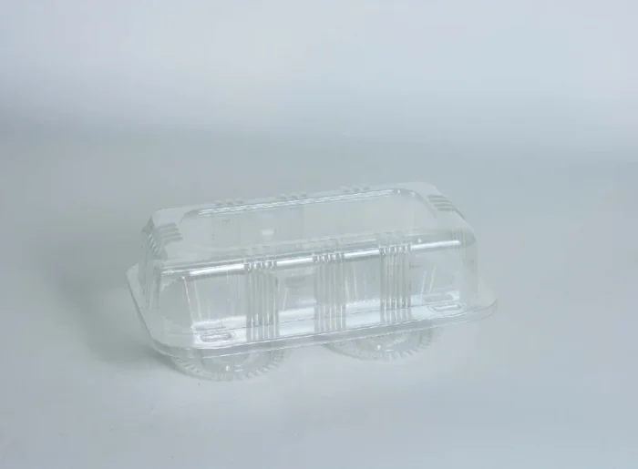 Clear muffin packaging by JC Packaging displaying a two-cell transparent muffin container, ensuring your baked goods are seen and protected.
