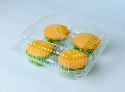 "Transparent quad muffin packaging filled with vibrant yellow muffins on www.jcpackaging.net, highlighting product freshness and quality."