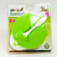 "Green weaning bowl with spoon for babies by Bright Beginnings, packaged and ready for purchase - find this and more in the category banners at www.jcpackaging.net."