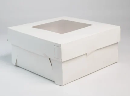 "Sturdy white paper cake box with transparent window, perfect for showcasing confectionery delights - find it at www.jcpackaging.net"