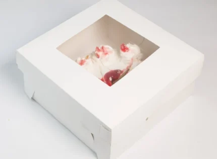 "Exquisite white paper cake box with a glimpse of a sumptuous strawberry cake inside, presented by www.jcpackaging.net"