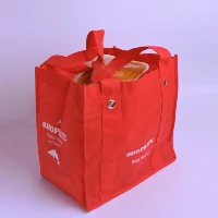 "Red reusable shopping bag filled with groceries, part of eco-friendly category banners at www.jcpackaging.net."