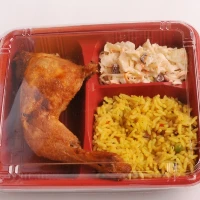 "Delectable meal in a red tray featuring roasted chicken, rice, and pasta salad – Discover more in our category banners at www.jcpackaging.net."