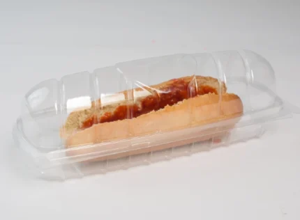 "Clear hot dog clamshell packaging by JC Packaging, showcasing a tasty hot dog inside, ideal for food safety and portability."