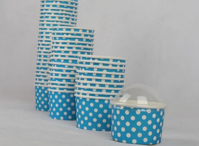 "A collection of medium-sized blue ice cream cups with white polka dots, perfect for serving sweet treats from www.jcpackaging.net."