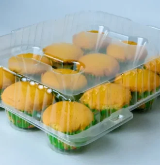 "Transparent pack showcasing a dozen muffins with vibrant green liners, a testament to JC Packaging's commitment to quality presentation."