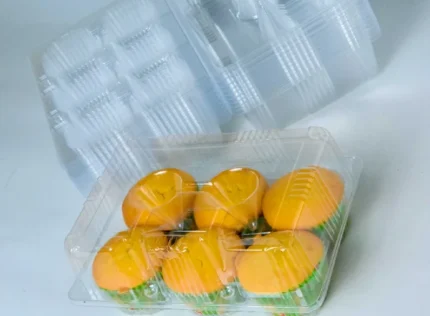 "Overhead angle of JC Packaging's Six-Muffin Display Case with a reflective sheen, showcasing six golden muffins in a secure and transparent package."