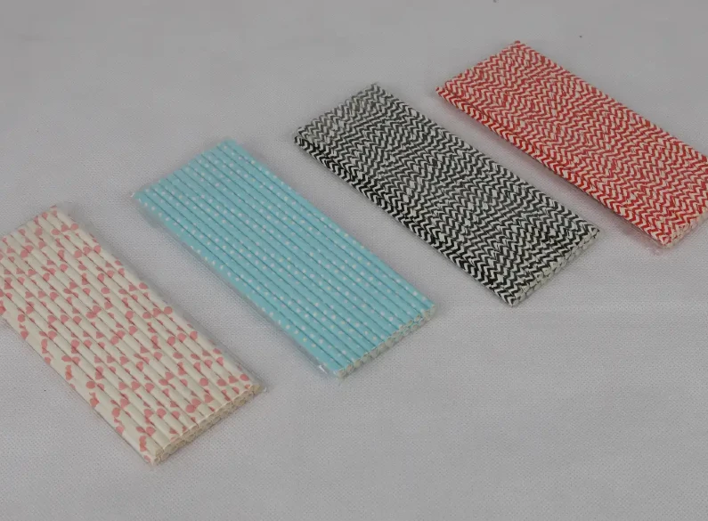 "An assortment of eco-friendly paper straws in various patterns and colors, available at www.jcpackaging.net."