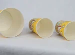 "Three varying sizes of yellow popcorn buckets with a classic cinema-style design from www.jcpackaging.net."