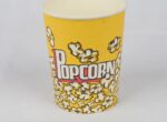 "A single 32oz yellow popcorn bucket with a delightful popcorn pattern, available at www.jcpackaging.net."