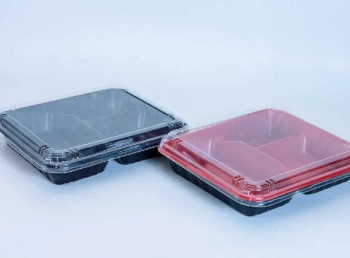 "Stack of JC Packaging Meal Prep Tray Packaging in clear and red variations, exemplifying quality and choice - Shop the collection at www.jcpackaging.net"