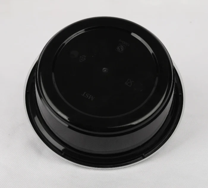 "Top-down view of a black round food storage container by JC Packaging, emphasizing its robust and user-friendly design."