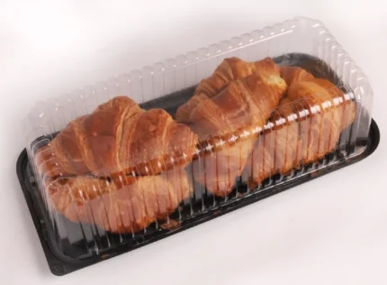 "Fresh croissants in a CrustKeeper Dome Container by JC Packaging, ensuring maximum freshness with a see-through design and secure black base."