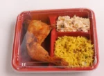 "Appetizing prepped meal in a clamshell meal tray with rice, vegetables, and grilled chicken, highlighting JC Packaging's quality design."