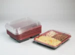 "Stack of JC Packaging's 3-division takeout containers beside a filled one, highlighting the perfect pack for meal portions and delivery."