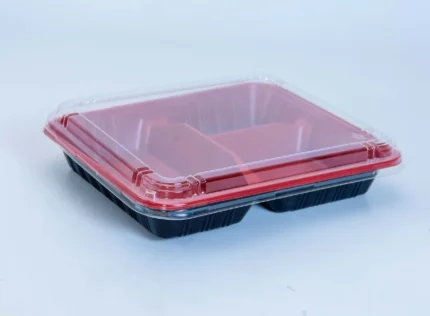 "Durable black and red clamshell meal tray with three compartments, ideal for takeout and delivery services - JC Packaging's sustainable option."